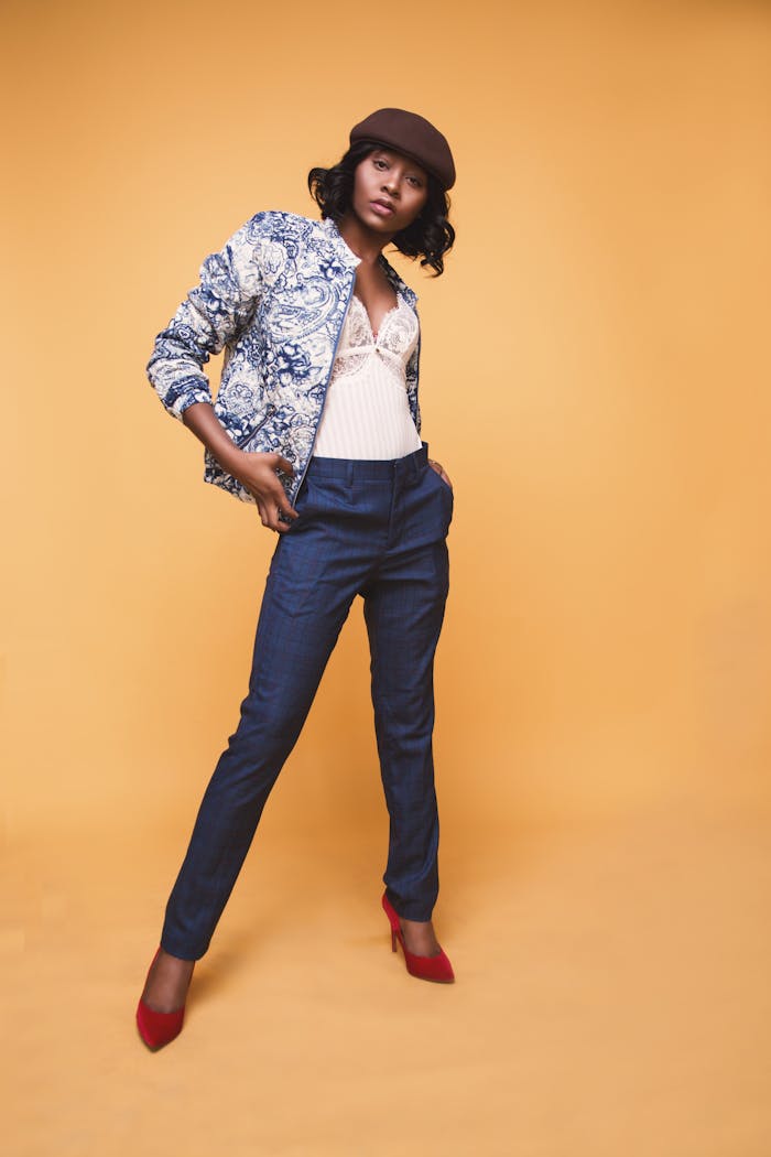 Stylish African American woman posing confidently in studio setting.